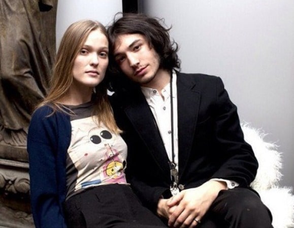 On the right side is Ezra miller, and On the left side of the photo is Erin Urb Posing for the image.